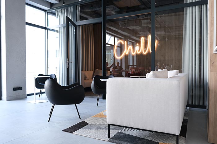 chemnovatic's kitchen and a neon in the shape of a word "chill", sofa, armchair