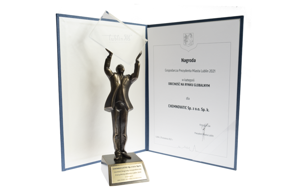 mayor of lublin award, a statue holding a glass and a certificate behind it